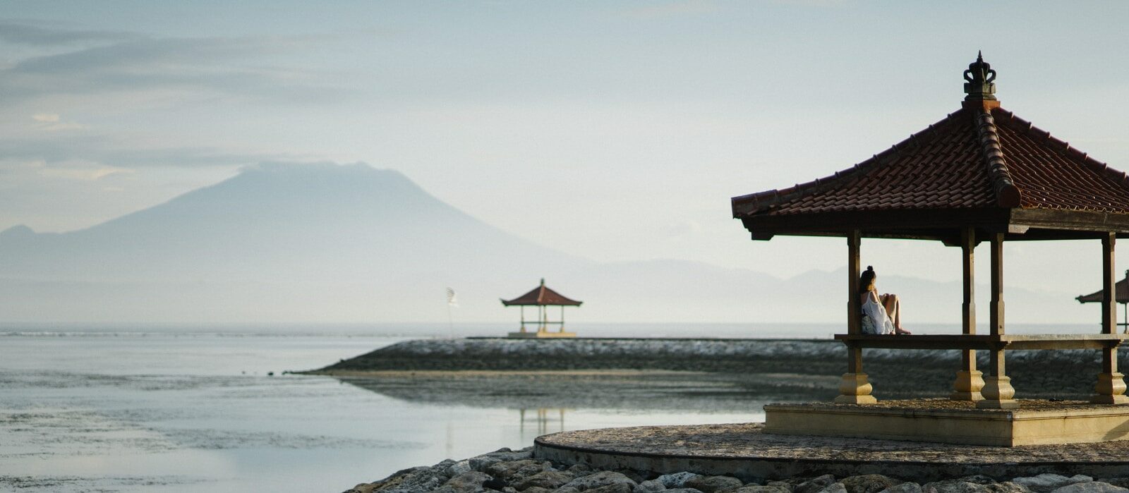 brown gazebo near sea closeup photography