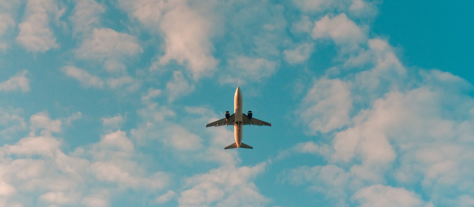 white airplane flying in the sky during daytime